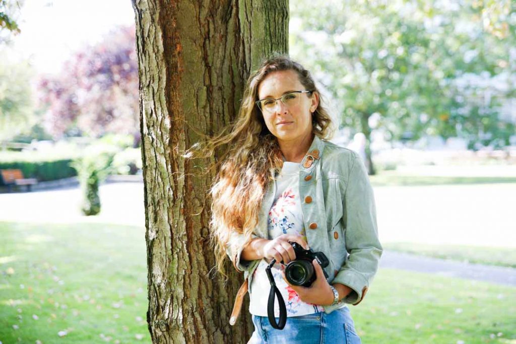 Photographer holding camera on a personal brand shoot