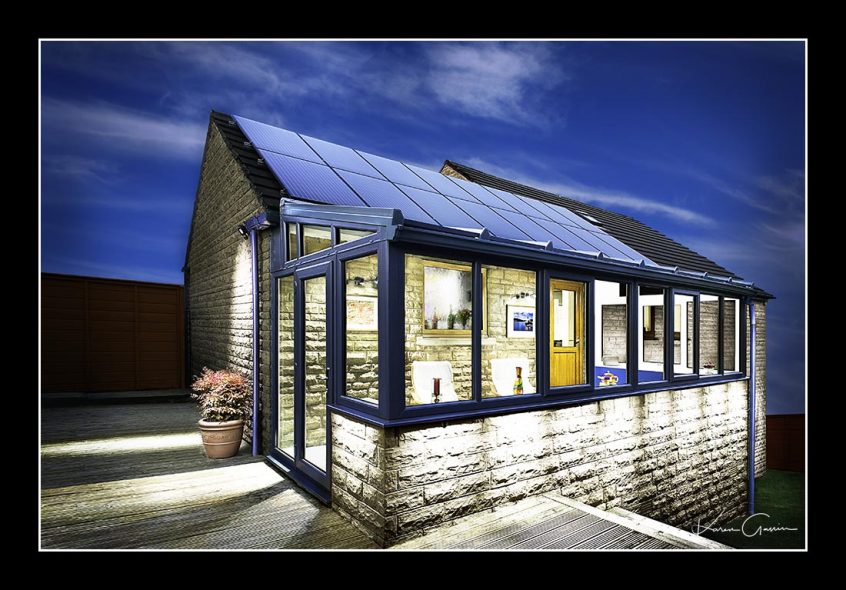 Distinctive lighting style photo of a conservatory with the house in the background