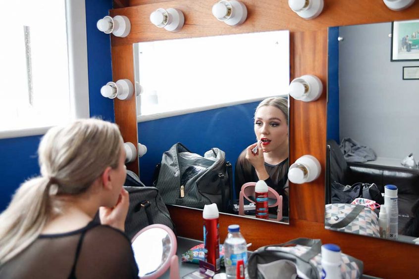 Putting on make up before a show